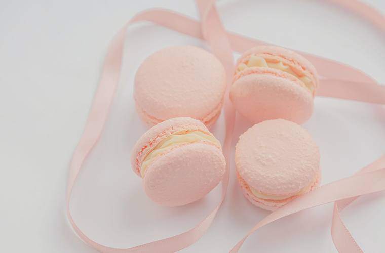 Pink macarons tangled in a pink ribbon