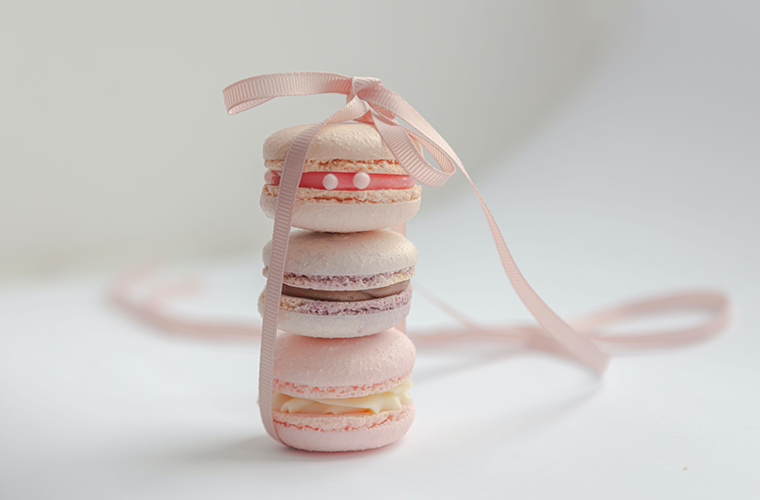 A stack of three macarons tied with a ribbon