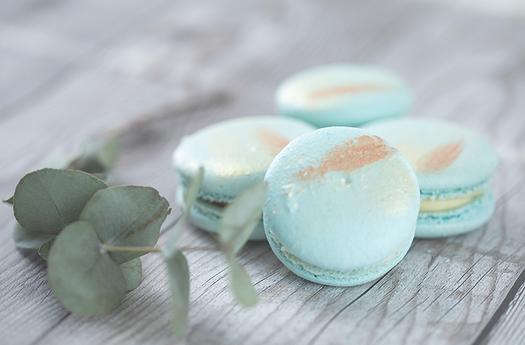 Pale blue macarons among gum leaves