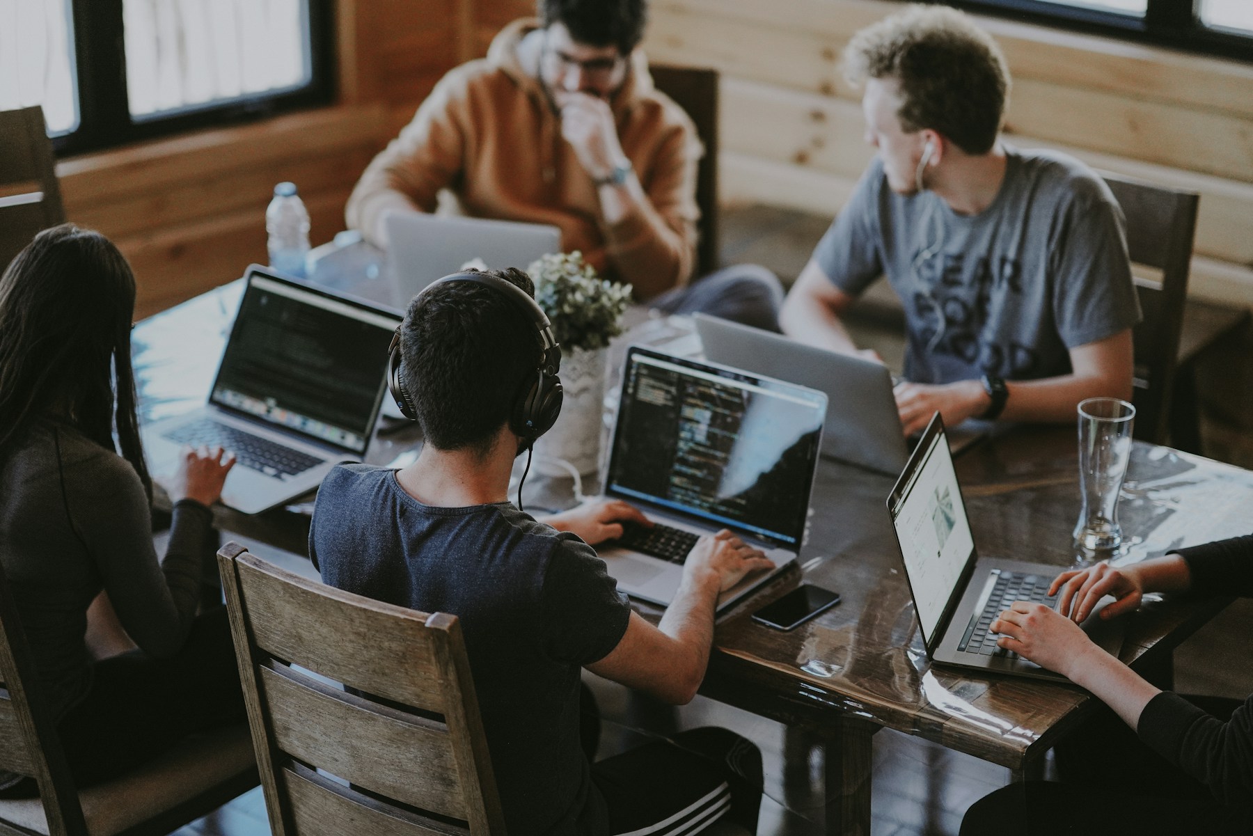 Colleagues collaborating around a table in a bright modern office